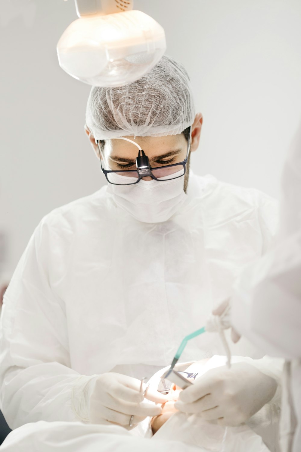 Dr. Usman Tariq performing a precise, painless dental procedure under the clinic light