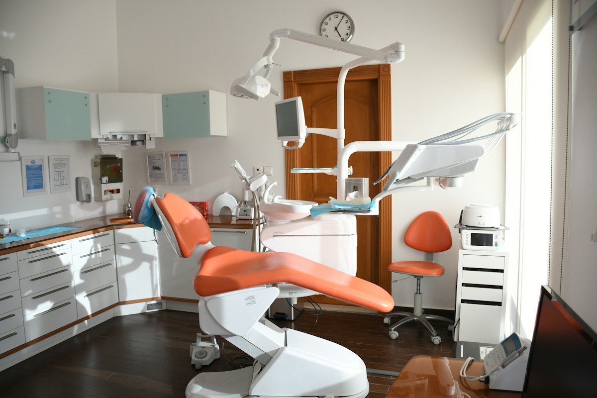 SmileCraft's bright family treatment suite with a child-friendly orange dental chair
